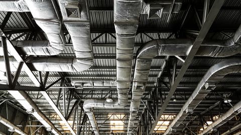 Ducting suspended from an industrial ceiling